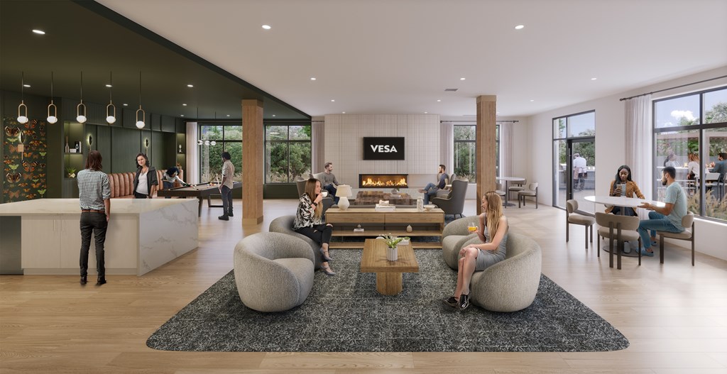 A modern lounge area with people sitting and standing around.